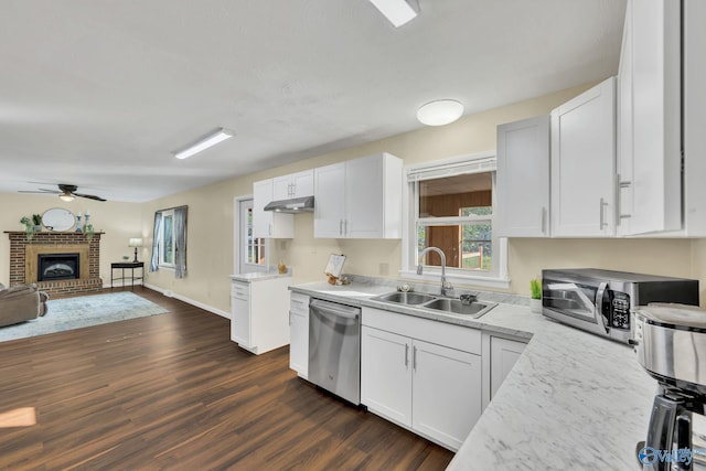 kitchen featuring stainless steel appliances, white cabinetry, and sink