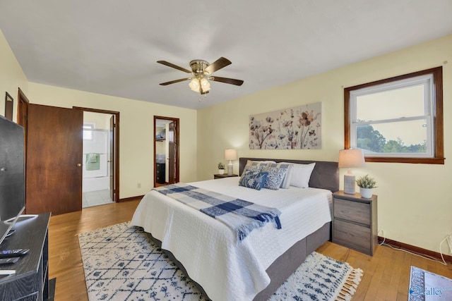 bedroom featuring ensuite bathroom, ceiling fan, and light hardwood / wood-style floors