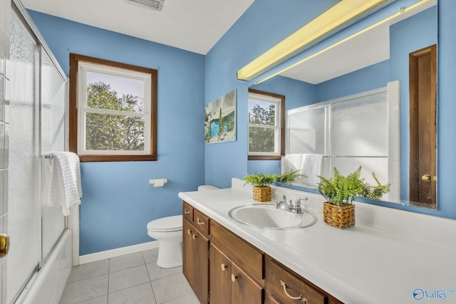 full bathroom featuring tile patterned floors, vanity, toilet, and enclosed tub / shower combo