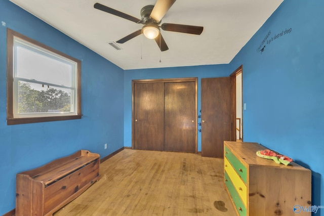 unfurnished bedroom featuring ceiling fan, a closet, and light hardwood / wood-style floors