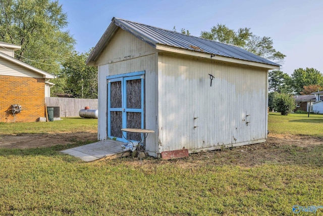 view of outbuilding featuring a yard