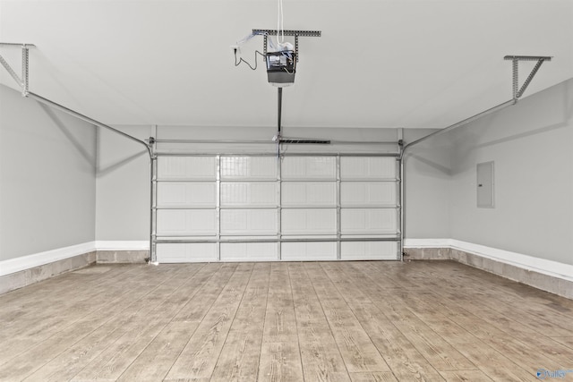 garage with electric panel and a garage door opener