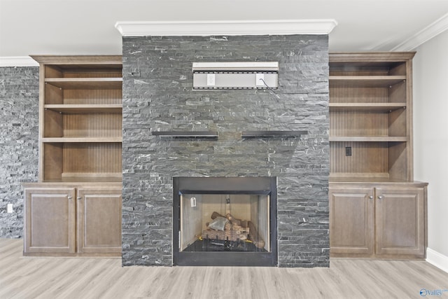 room details with a fireplace, crown molding, and wood finished floors