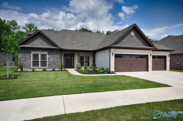 7528 Flint Crossing Cir, Owens Cross Roads, AL 35763 - craftsman-style house featuring a garage, driveway, a front lawn, and brick siding