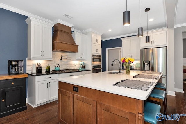 7528 Flint Crossing Cir, Owens Cross Roads, AL 35763 - kitchen featuring premium range hood, stainless steel appliances, backsplash, dark wood-style floors, and ornamental molding
