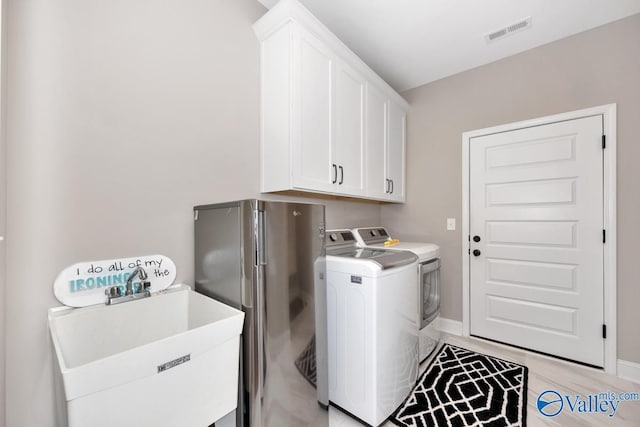 7528 Flint Crossing Cir, Owens Cross Roads, AL 35763 - washroom with washing machine and dryer and cabinet space