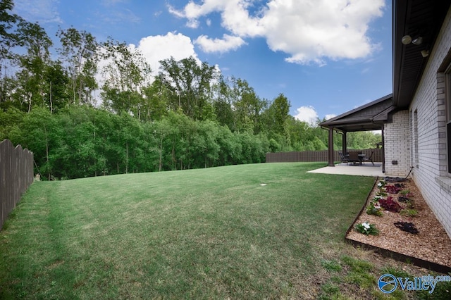 7528 Flint Crossing Cir, Owens Cross Roads, AL 35763 - fenced backyard with a patio area
