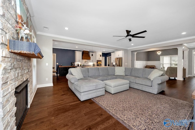7528 Flint Crossing Cir, Owens Cross Roads, AL 35763 - living room with a ceiling fan, ornamental molding, a stone fireplace, recessed lighting, and dark wood-type flooring