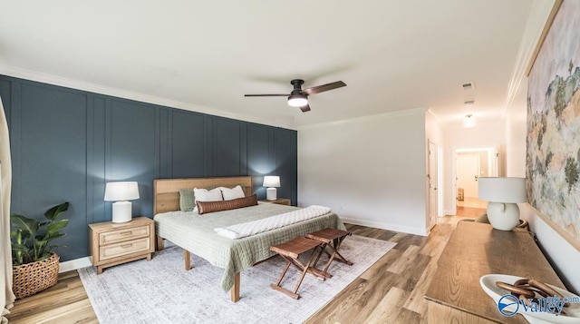 7326 Vidette Ln SE, Owens Cross Roads, AL 35763 - bedroom featuring crown molding, light wood-style floors, ceiling fan, and a decorative wall