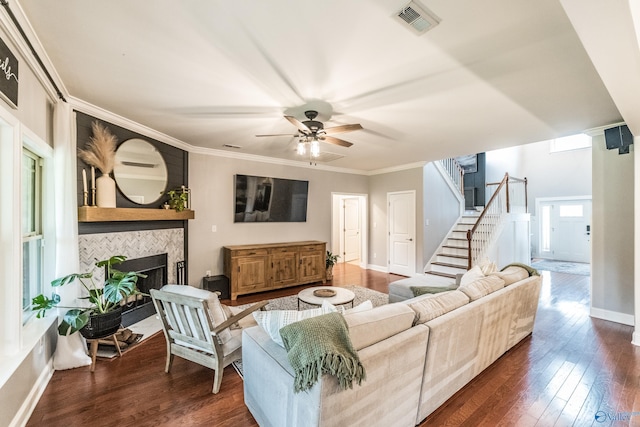 7326 Vidette Ln SE, Owens Cross Roads, AL 35763 - living room featuring dark wood finished floors, stairway, a tile fireplace, a ceiling fan, and ornamental molding