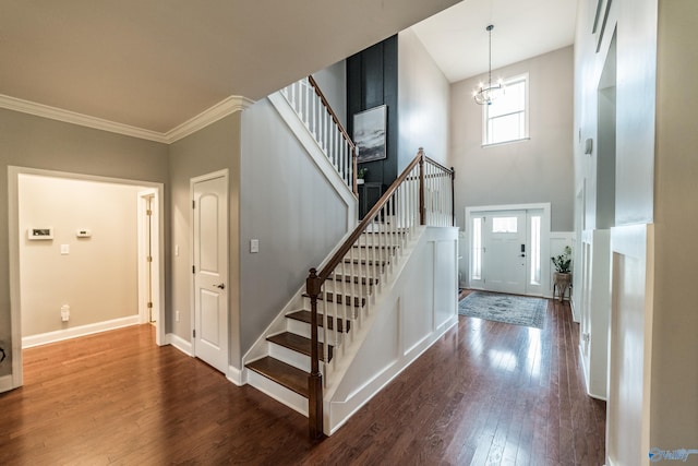 7326 Vidette Ln SE, Owens Cross Roads, AL 35763 - entryway featuring stairs, dark wood finished floors, a chandelier, crown molding, and a high ceiling