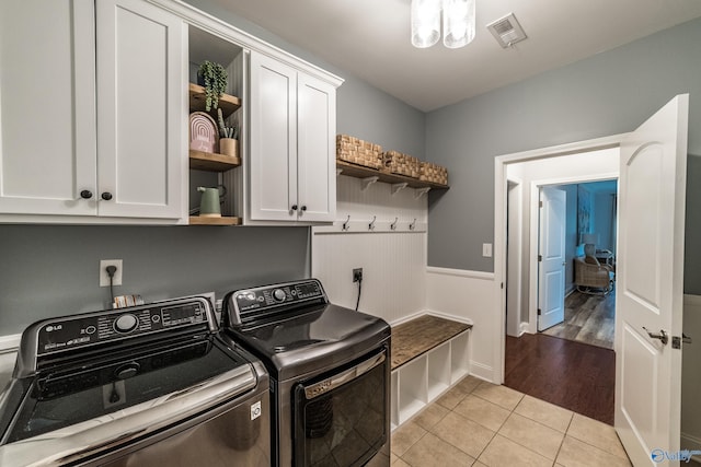 7326 Vidette Ln SE, Owens Cross Roads, AL 35763 - washroom featuring cabinet space, washer and clothes dryer, and light tile patterned floors