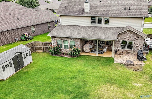 7326 Vidette Ln SE, Owens Cross Roads, AL 35763 - rear view of house with a patio area, a storage unit, a fenced backyard, and roof with shingles