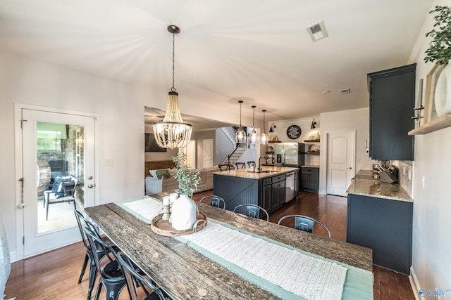 7326 Vidette Ln SE, Owens Cross Roads, AL 35763 - dining room with a chandelier and dark wood-type flooring