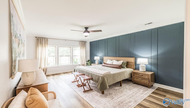 7326 Vidette Ln SE, Owens Cross Roads, AL 35763 - bedroom featuring wood finished floors, a decorative wall, and ceiling fan