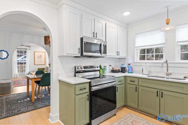 kitchen with sink, white cabinetry, appliances with stainless steel finishes, and green cabinetry