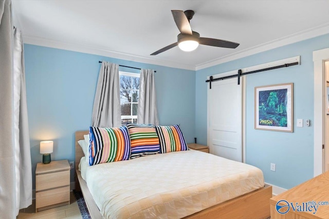 bedroom featuring ceiling fan, a barn door, ornamental molding, and light hardwood / wood-style floors