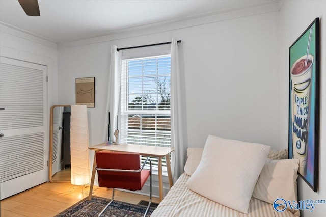 sitting room featuring hardwood / wood-style flooring and ornamental molding