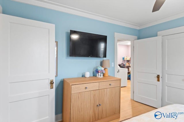 bedroom featuring light hardwood / wood-style flooring, ceiling fan, and ornamental molding