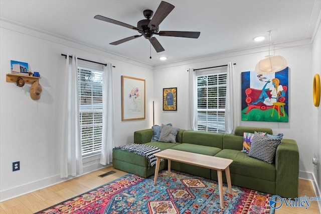 living room with ceiling fan, crown molding, and wood-type flooring