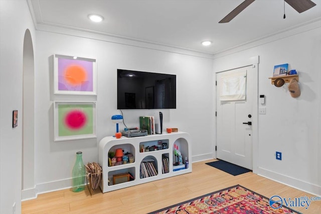 foyer entrance featuring ceiling fan, hardwood / wood-style floors, and ornamental molding