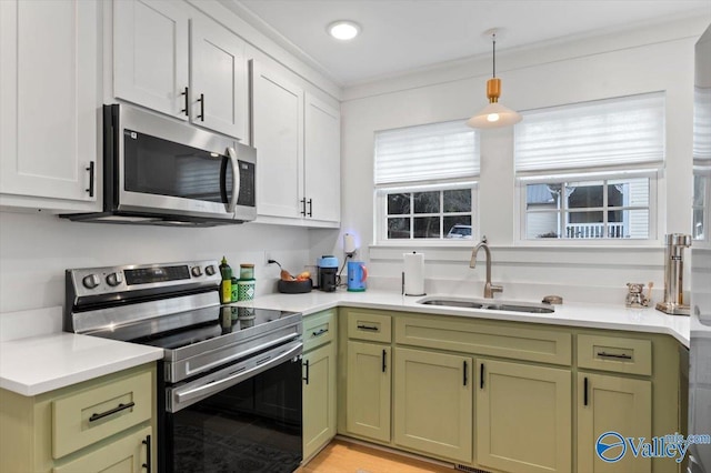 kitchen with sink, white cabinetry, a wealth of natural light, and stainless steel appliances