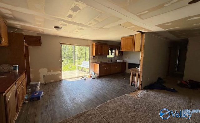50 Hudgins Dr, Attalla, AL 35954 - kitchen featuring dark wood-style floors, brown cabinetry, and dark countertops