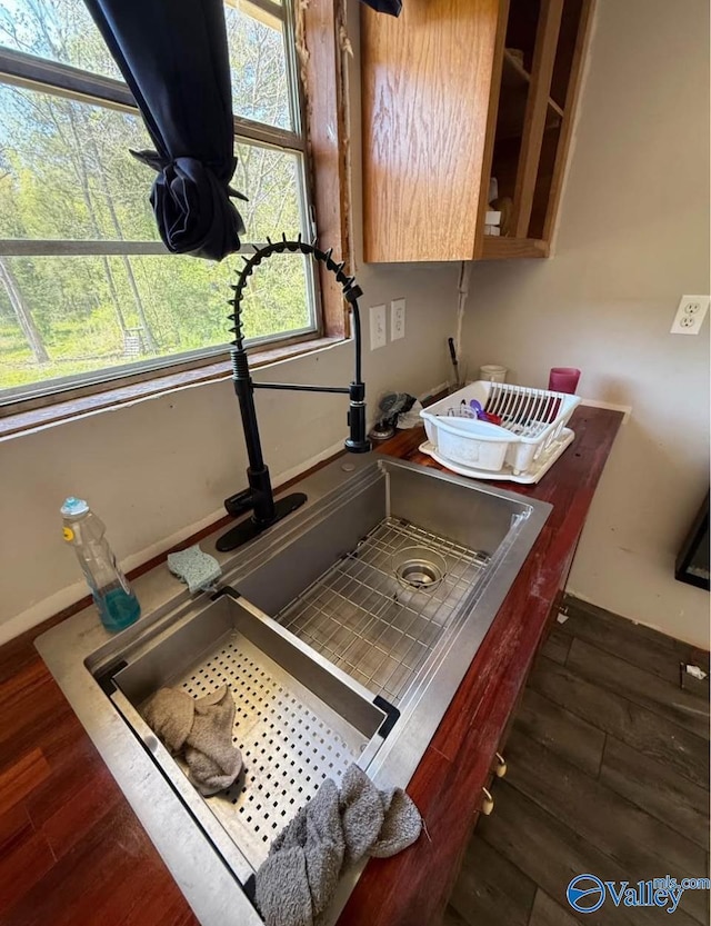 50 Hudgins Dr, Attalla, AL 35954 - kitchen view of wood finished floors, baseboards, and a sink