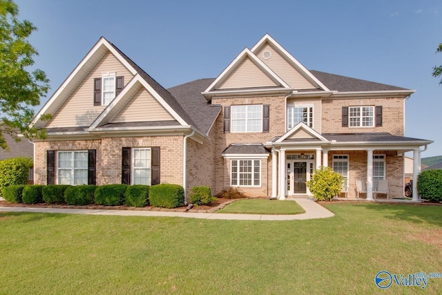 craftsman-style house with covered porch and a front yard