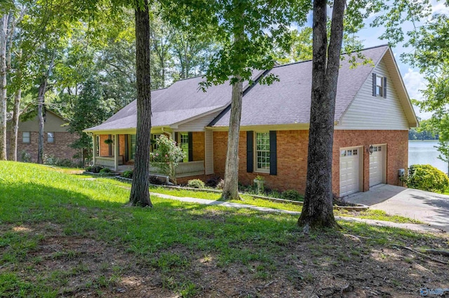 814 E Haven Dr, Glencoe, AL 35905 - view of front of home featuring brick siding, driveway, a garage, a porch, and a front lawn
