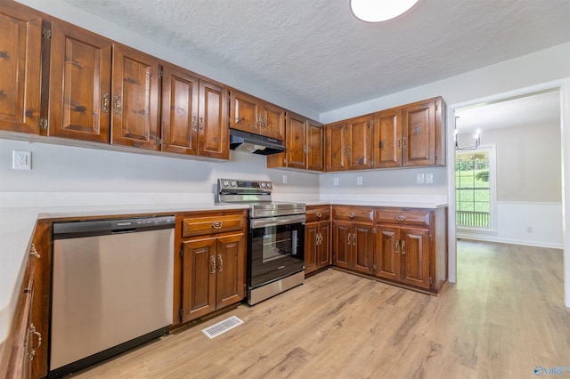 814 E Haven Dr, Glencoe, AL 35905 - kitchen featuring appliances with stainless steel finishes, under cabinet range hood, light wood-type flooring, light countertops, and a textured ceiling