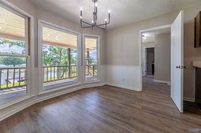 814 E Haven Dr, Glencoe, AL 35905 - unfurnished dining area with a chandelier, dark wood finished floors, and a wainscoted wall