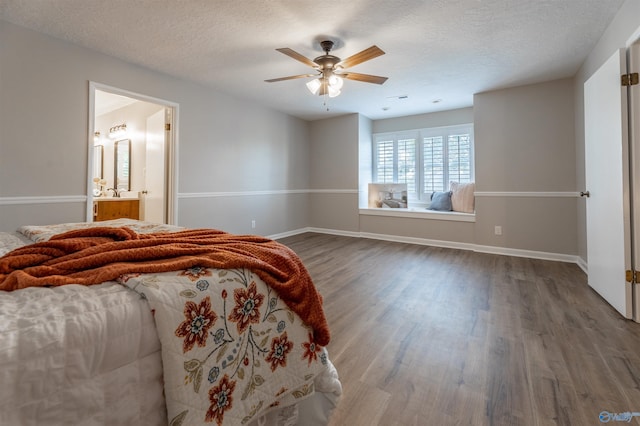 814 E Haven Dr, Glencoe, AL 35905 - bedroom with dark wood finished floors, a textured ceiling, ceiling fan, and ensuite bath