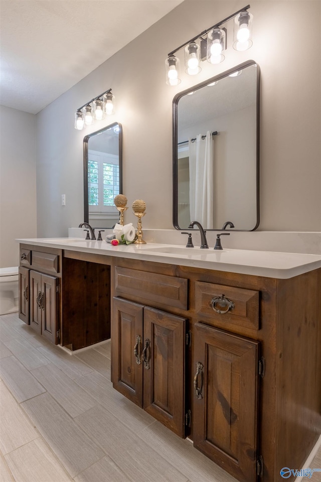 814 E Haven Dr, Glencoe, AL 35905 - bathroom with double vanity and toilet