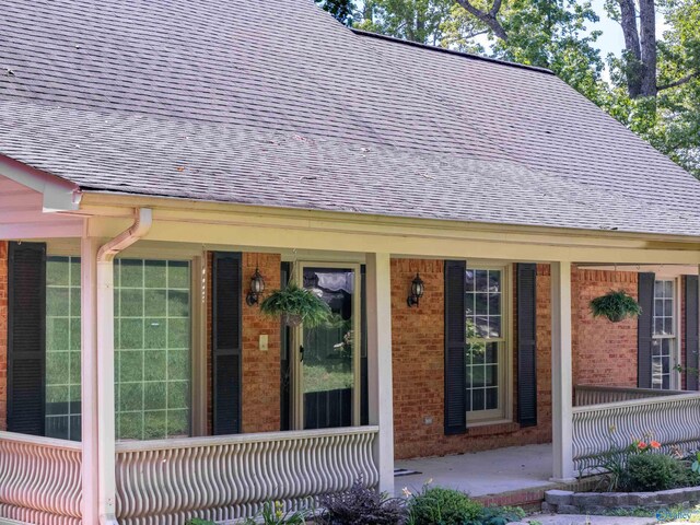 814 E Haven Dr, Glencoe, AL 35905 - doorway to property with a shingled roof, brick siding, and a porch