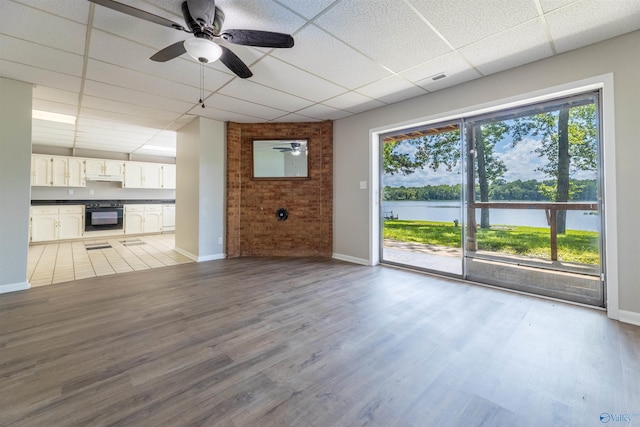814 E Haven Dr, Glencoe, AL 35905 - unfurnished living room featuring a drop ceiling, a ceiling fan, light wood-style floors, and a water view