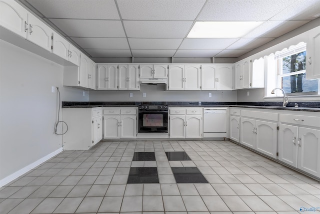 814 E Haven Dr, Glencoe, AL 35905 - kitchen with oven, dishwasher, under cabinet range hood, dark countertops, and a drop ceiling