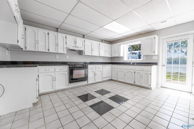 814 E Haven Dr, Glencoe, AL 35905 - kitchen featuring oven, under cabinet range hood, dishwasher, a paneled ceiling, and white cabinets