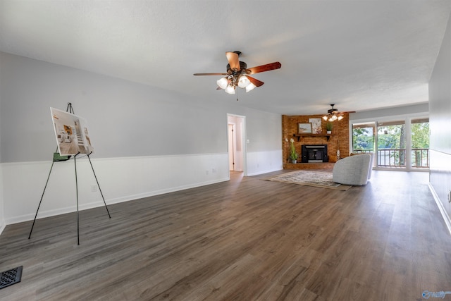 814 E Haven Dr, Glencoe, AL 35905 - unfurnished living room with ceiling fan, a brick fireplace, wood finished floors, and a wainscoted wall