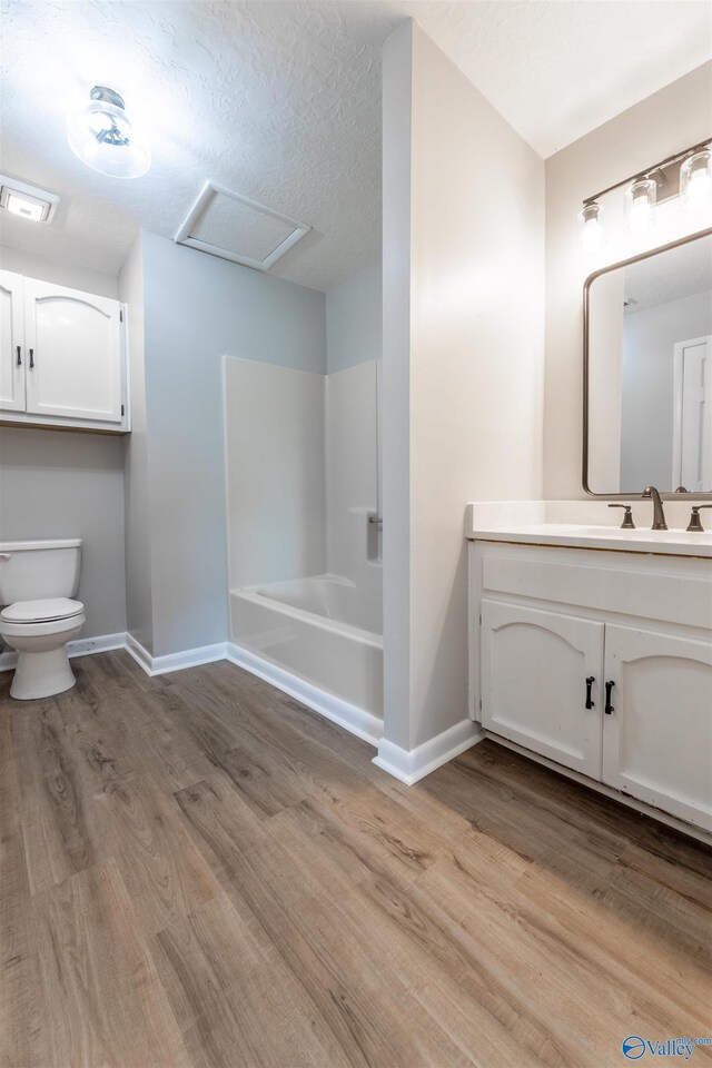 814 E Haven Dr, Glencoe, AL 35905 - bathroom with wood finished floors, vanity, and bathing tub / shower combination