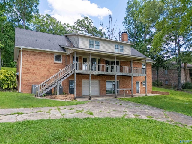 814 E Haven Dr, Glencoe, AL 35905 - back of property with a chimney, brick siding, a garage, and a lawn