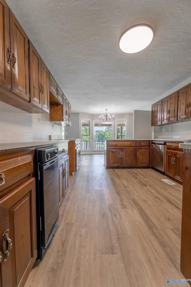 814 E Haven Dr, Glencoe, AL 35905 - kitchen with dishwasher, light wood-style floors, a chandelier, brown cabinets, and a textured ceiling