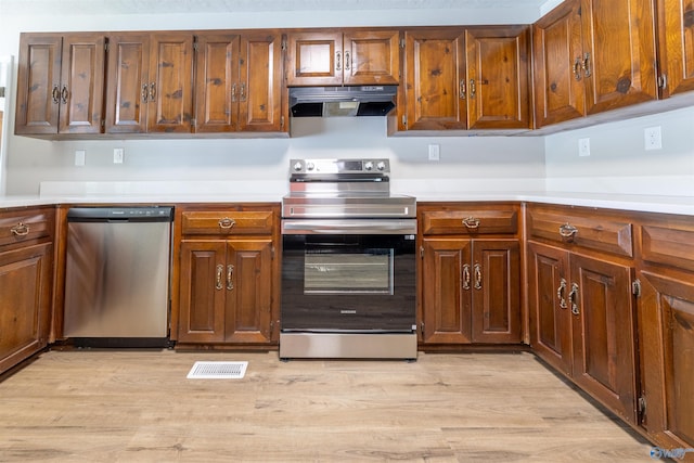 814 E Haven Dr, Glencoe, AL 35905 - kitchen with stainless steel appliances, range hood, light countertops, and light wood finished floors