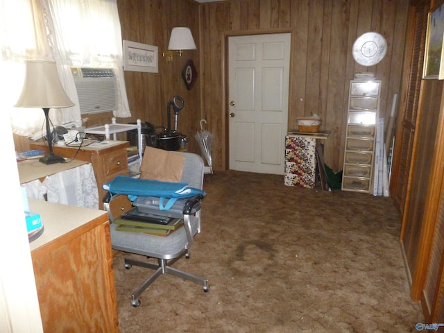 carpeted office space featuring wooden walls