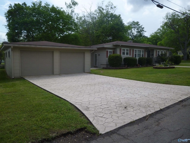 ranch-style house featuring an attached garage, decorative driveway, and a front lawn