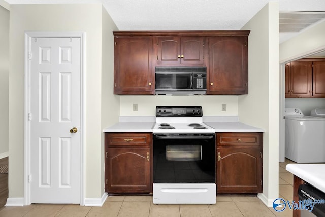 kitchen featuring light tile patterned flooring, a textured ceiling, washing machine and clothes dryer, dishwasher, and white range with electric cooktop