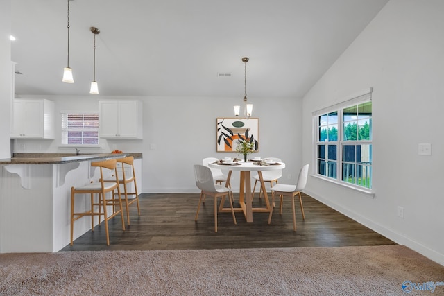 2452 Belltown Dr, Huntsville, AL 35803 - dining room with plenty of natural light, baseboards, lofted ceiling, dark wood-type flooring, and dark carpet