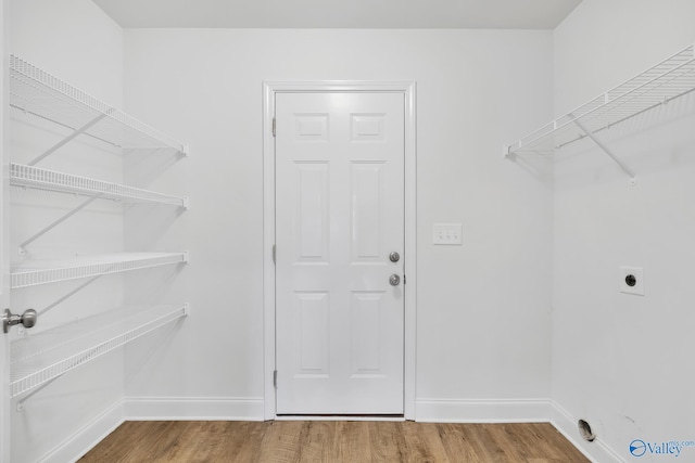 2452 Belltown Dr, Huntsville, AL 35803 - laundry area featuring wood finished floors, baseboards, and hookup for an electric dryer