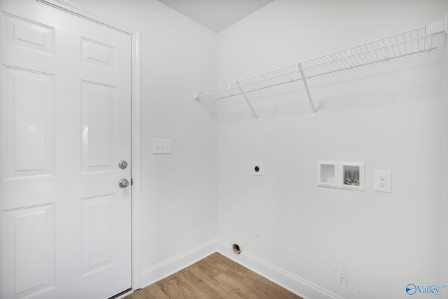 2452 Belltown Dr, Huntsville, AL 35803 - laundry area featuring hookup for an electric dryer, baseboards, hookup for a washing machine, and light wood-style flooring