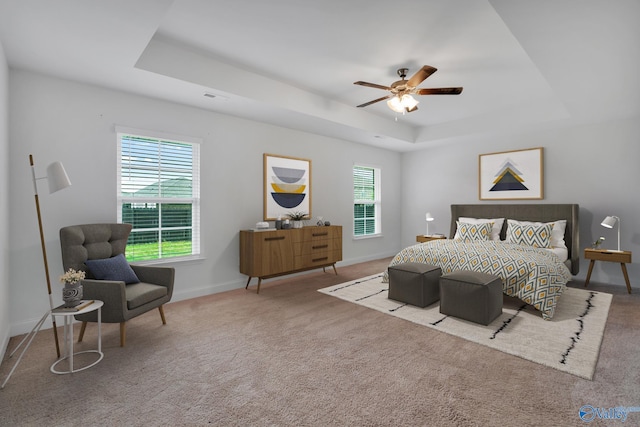 2452 Belltown Dr, Huntsville, AL 35803 - carpeted bedroom featuring a tray ceiling, baseboards, and a ceiling fan